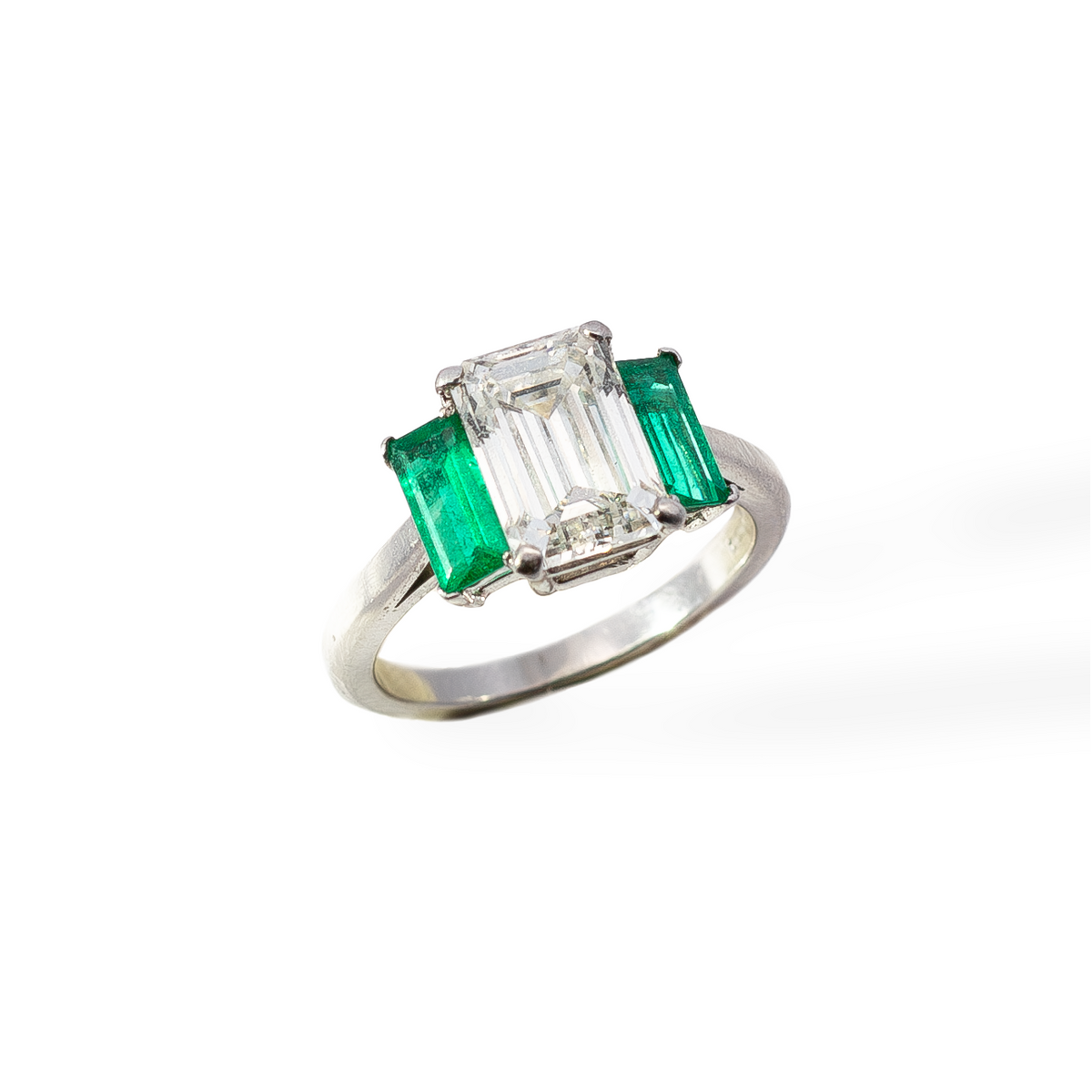 Ring with emerald and diamond on a white background
