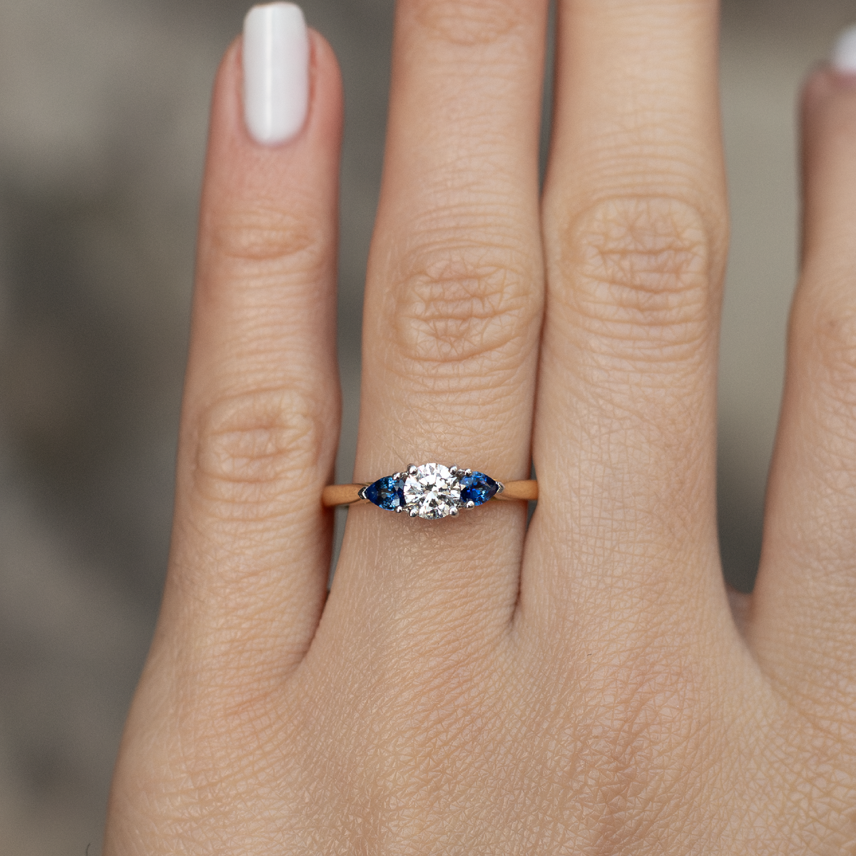0.40ct Round Diamond And Pear Cut Sapphire Three Stone Ring