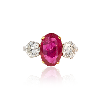 Oval Cut Ruby and Round Diamond Three Stone Ring