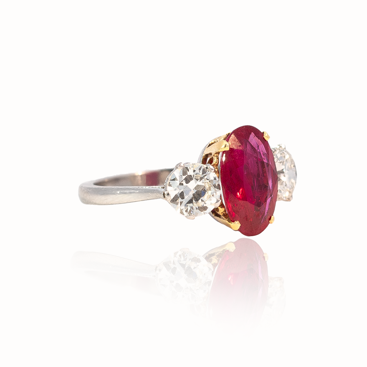 Oval Cut Ruby and Round Diamond Three Stone Ring