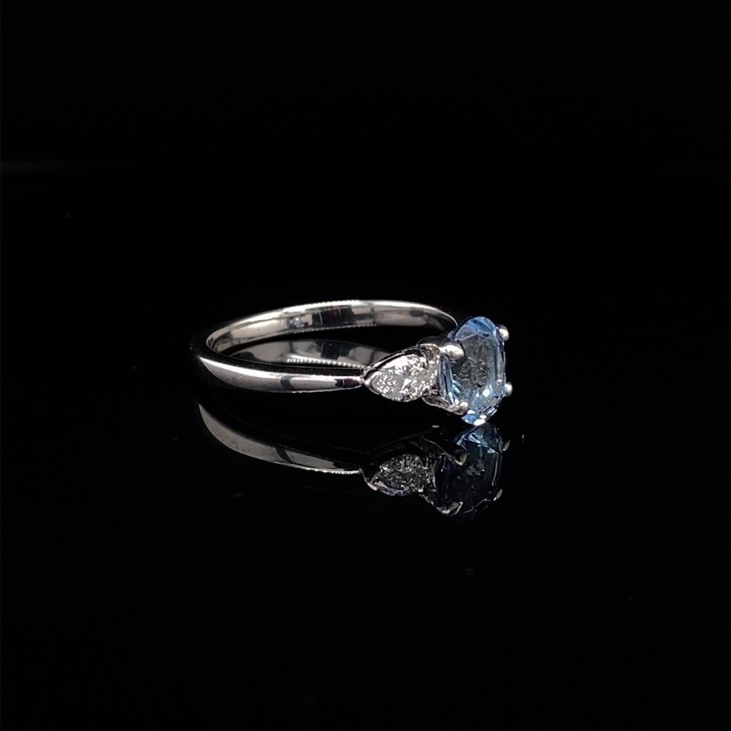 0.69ct Oval Cut Aquamarine and Diamond Three Stone Ring