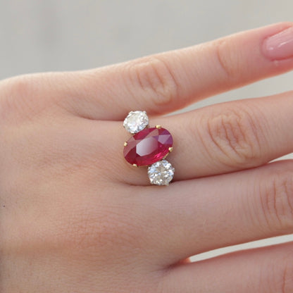 Oval Cut Ruby and Round Diamond Three Stone Ring